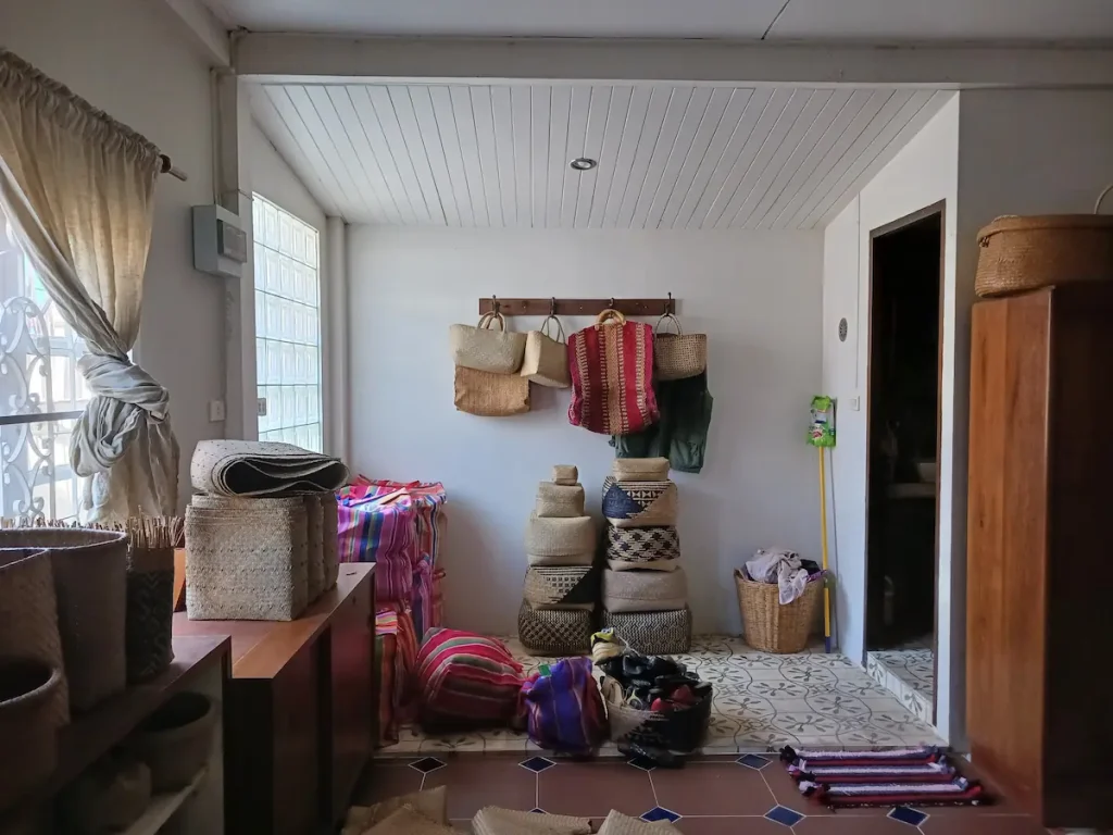 床や棚の上に並べられた大小様々なカチュー(水草の一種)の収納ボックスや壁に掛けられたカチューのトートバッグ